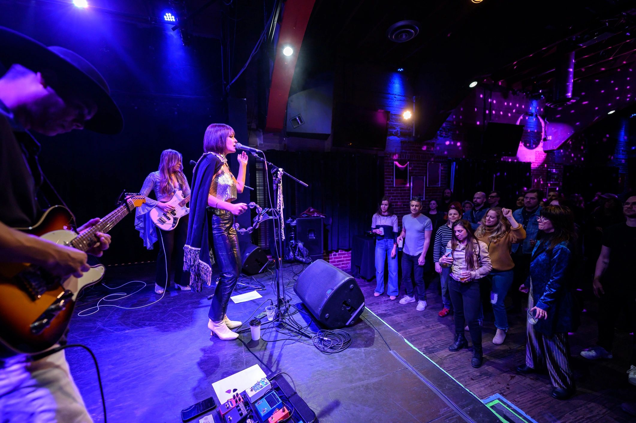 band performing live on stage crowd